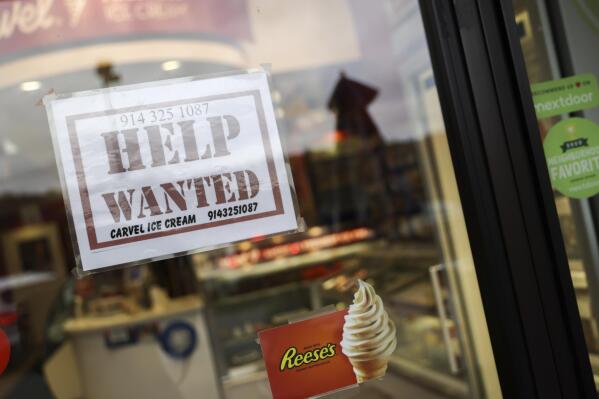 A help wanted sign in a storefront, Tuesday, Nov. 1, 2022, in Bedford, N.Y. The Federal Reserve may reach a turning point this week as it announces what's expected to be another substantial three-quarter-point hike in its key interest rate. The Fed's hikes have already led to much costlier borrowing rates, ranging from mortgages to auto and business loans.   (AP Photo/Julia Nikhinson)