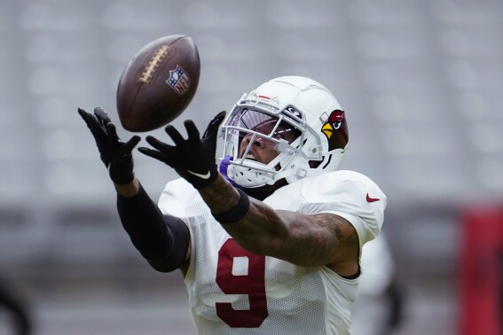 Arizona Cardinals linebacker Isaiah Simmons reaches up to make a catch during NFL football training camp Thursday, Aug. 3, 2023, in Glendale, Ariz. (AP Photo/Ross D. Franklin)