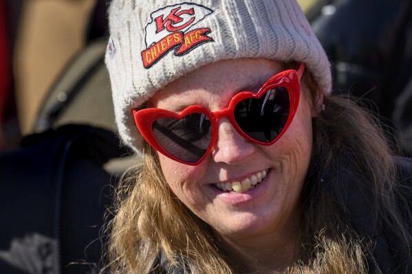 A Kansas City Chiefs fan brought her Valentine's Day spirit to the Super Bowl victory rally in Kansas City, Mo., Wednesday, Feb. 14, 2024. (AP Photo/Reed Hoffmann)