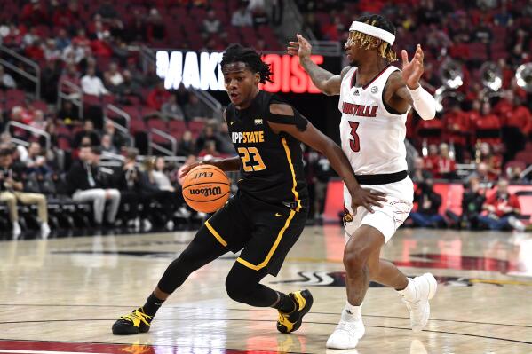 Appalachian State guard Terence Harcum (23) drives around Louisville guard El Ellis (3) during the first half of an NCAA college basketball game in Louisville, Ky., Tuesday, Nov. 15, 2022. (AP Photo/Timothy D. Easley)