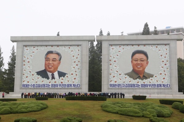 FILE - Citizens visit the portraits of the country's late leaders Kim Il Sung and Kim Jong Il on the occasion of the 78th founding anniversary of the Worker's Party of Korea in Pyongyang, North Korea, Oct. 10, 2023. The White House says that North Korea has delivered more than 1,000 containers of military equipment and munitions to Russia for its ongoing war in Ukraine. White House National Security Council spokesman John Kirby said Friday the U.S. believes Kim is seeking sophisticated Russian weapons technologies in return for the munitions to boost North Korea’s military. (AP Photo/Jon Chol Jin, file)