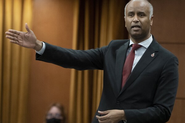 FILE - Housing and Diversity and Inclusion Minister Ahmed Hussen rises during Question Period, in Ottawa, Ontario, April 28, 2022. Ahmed, who is now Canada's Minister of International Development, said Wednesday, Feb. 28, 2024, that Canada is working to airdrop humanitarian aid to the Gaza Strip as soon as possible. (Adrian Wyld/The Canadian Press via AP)