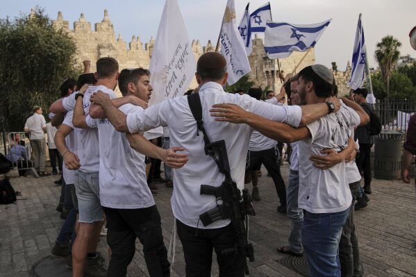 Israelis participate in a march marking Jerusalem Day, an Israeli holiday celebrating the capture of east Jerusalem in the 1967 Mideast war, in Damascus Gate of Jerusalem's Old City, Monday, May 26, 2025. (AP Photo/Leo Correa)
