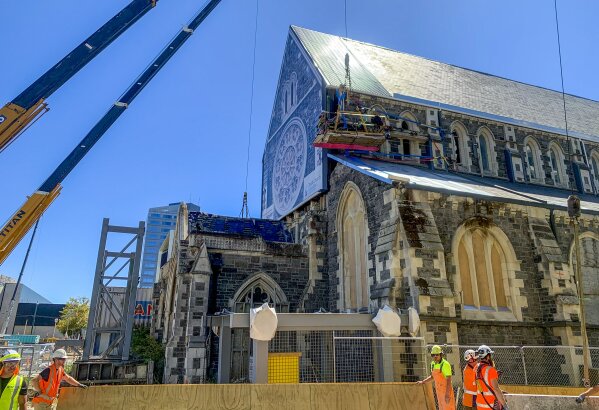 Construction staff work on the 2011 earthquake damaged Christ Church Cathedral in central Christchurch, New Zealand, on Feb. 11, 2021. The Christ Church Cathedral was arguably New Zealand's most iconic building before much of it crumbled during an earthquake 10 years ago. The years of debate that followed over whether the ruins should be rebuilt or demolished came to symbolize the paralysis that has sometimes afflicted the broader rebuild of Christchurch. But as the city on Monday, Feb. 22 marks one decade since the quake struck, killing 185 people and upending countless more lives, there are finally signs of progress on the cathedral. It's being rebuilt to look much like the original that was finished in 1904, only with modern-day improvements to make it warmer and safer. (AP Photo/Nick Perry)