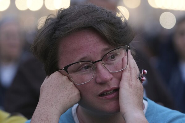A woman attends a rosary prayer for the late Pope Francis, in St. Peter's Square at the Vatican, Monday April 21, 2025. (AP Photo/Alessandra Tarantino)
