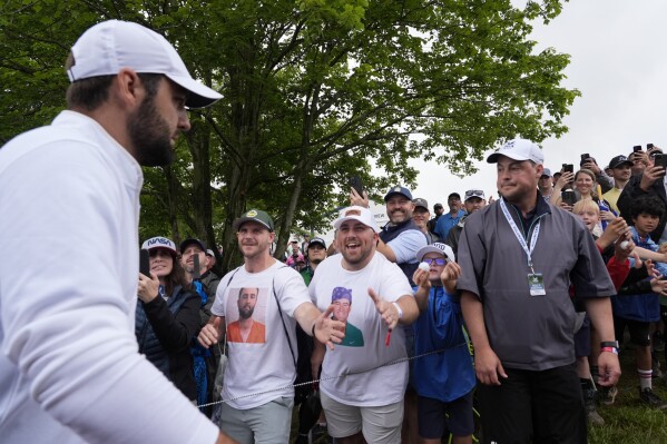 Scottie Scheffler is greeted by fans after the second round of the PGA Championship golf tournament at the Valhalla Golf Club, May 17, 2024, in Louisville, Ky. (AP Photo/Matt York, file)