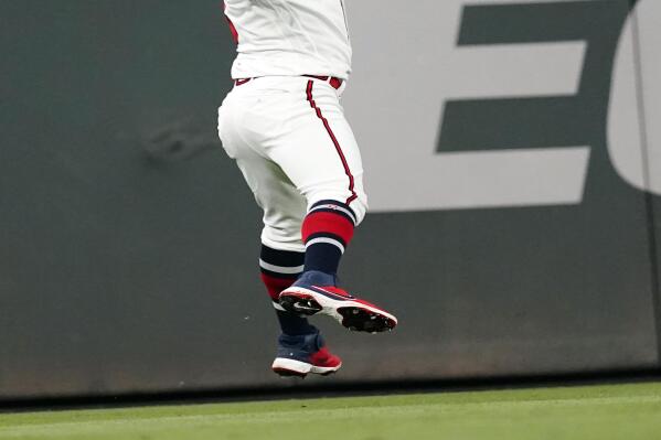 A flyball from Philadelphia Phillies' Matt Vierling gets past Atlanta Braves left fielder Eddie Rosario (8) in the ninth inning of a baseball game Tuesday, Sept. 28, 2021, in Atlanta. Rosario was charged with an error. (AP Photo/John Bazemore)