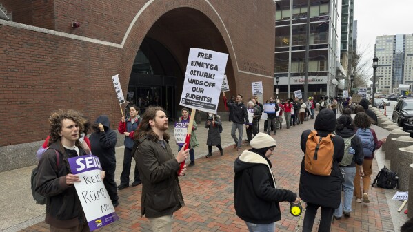 Protesters gather outside federal court during a hearing for Rumeysa Ozturk, a Tufts University doctoral student from Turkey who was detained by immigration authorities, April 3, 2025, in Boston. (AP Photo/Rodrique Ngowi, File)