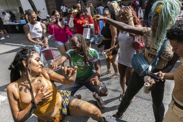People dance during the Queer Juneteenth Block Party, sponsored by The Center, Sunday, June 18, 2023, in New York. (AP Photo/Jeenah Moon)