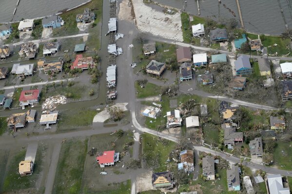 Buildings and homes are damaged in the aftermath of Hurricane Laura Thursday, Aug. 27, 2020, near Lake Charles, La. (AP Photo/David J. Phillip)