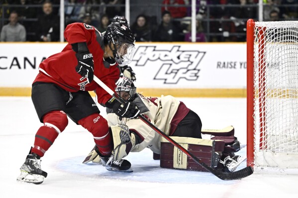 Ottawa's Mikyla Grant-Mentis (13) takes a shot on Montreal's Ann-Renee Desbiens (35) during the second period of a PWHL hockey game Tuesday, Jan. 2, 2024, in Ottawa, Ontario. (Justin Tang/The Canadian Press via AP)