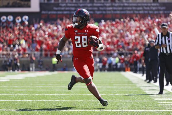 Texas Tech's Tahj Brooks (28) runs to score a touchdown during the first half of an NCAA college football game against Texas, Saturday, Sept. 24, 2022, in Lubbock, Texas. (AP Photo/Brad Tollefson)