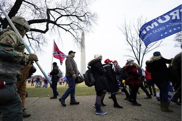 FILE - In this Jan. 6, 2021, file photo, Trump supporters gather on the Washington Monument grounds in advance of a rally in Washington. Both within and outside the walls of the Capitol, banners and symbols of white supremacy and anti-government extremism were displayed as an insurrectionist mob swarmed the U.S. Capitol. (AP Photo/Julio Cortez, File)