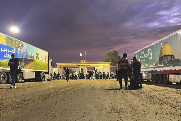 Humanitarian aid convoy for the Gaza Strip is parked at the Rafah crossing port, Egypt, Tuesday, Oct. 17, 2023. Hundreds of Palestinians in the Gaza Strip have fled their homes ahead of an expected Israeli ground invasion aimed at destroying Hamas after its fighters rampaged through southern Israel. (AP Photo/Omar Aziz)