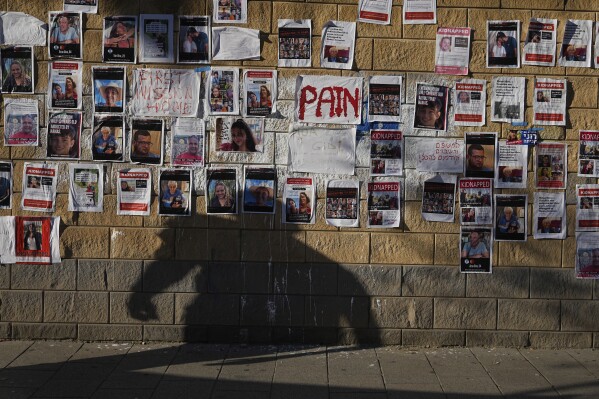 Photos of Israelis missing and held captive in Gaza, are displayed on a wall in Tel Aviv, Israel, Wednesday, Oct. 18, 2023. The Israeli army says some 200 people were kidnapped and taken to Gaza in Hamas' cross-border attack on Israel on Oct. 7. (AP Photo/Ohad Zwigenberg)