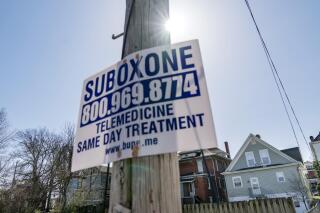 FILE - A sign advertising addiction treatment is posted to a utility pole in Huntington, W.Va., Friday, March 19, 2021. The influx of prescription opioids into West Virginia communities was the main driver of the state's drug crisis, more than poverty, job loss and other economic stressors, an epidemiologist testified Tuesday, April 12, 2022, at the ongoing trial against three major pharmaceutical companies. (AP Photo/David Goldman, File).