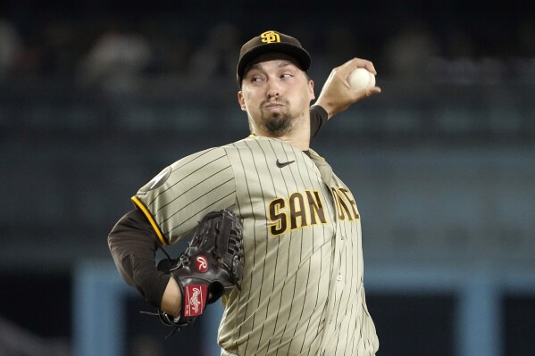 FILE -San Diego Padres starting pitcher Blake Snell throws to the plate during the first inning of a baseball game against the Los Angeles Dodgers Wednesday, Sept. 13, 2023, in Los Angeles. There are still some premium free agents available for Major League Baseball teams as the calendar nears March. Two-time Cy Young Winner Blake Snell, six-time All-Star J.D. Martinez and former MVP Cody Bellinger are among the players who haven't found a home. (AP Photo/Mark J. Terrill, File)