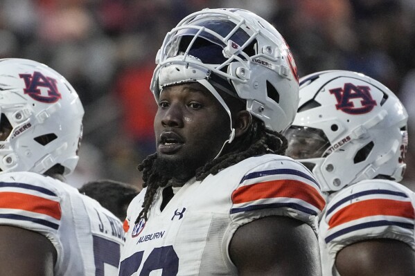 FILE - Auburn defensive lineman Marcus Harris stands in the huddle during a timeout in the second half of an NCAA college football game, Nov. 4, 2023, in Nashville, Tenn. Auburn All-Southeastern Conference defensive tackle Harris says he will skip his final season to enter the NFL draft. Harris, who was a first-team Associated Press All-SEC pick, made the announcement in a social media post Tuesday, Dec. 12. (AP Photo/George Walker IV, File)