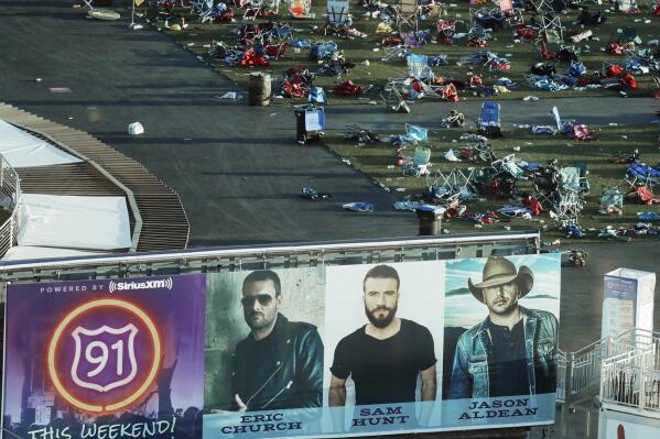 FILE - Personal belongings and debris litter the Route 91 Harvest festival grounds across the street from the Mandalay Bay resort and casino in Las Vegas on Oct. 3, 2017, after a mass shooting Oct. 1. A new documentary, “11 Minutes,” is an inside account of the 2017 massacre at a country music concert in Las Vegas. More than three hours long, the four-part documentary debuts on the Paramount+ streaming service Tuesday. (AP Photo/Marcio Jose Sanchez, File)