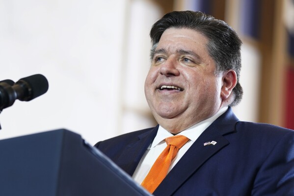 FILE - Gov. J.B. Pritzker, D-Ill., addresses the crowd before President Joe Biden delivers remarks on the economy, Wednesday, June 28, 2023, at the Old Post Office in Chicago. The Democratic governor and multibillionaire has been lavished with hundreds of gifts from around the world, ranging from a $950 bottle of Japanese whiskey to 35 cents — a quarter and dime, to be exact.(AP Photo/Evan Vucci, File))
