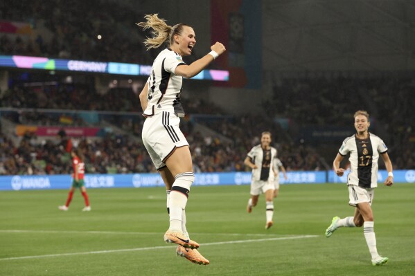 Germany's Klara Buehl, left, celebrates after scoring her side's third goal during the Women's World Cup Group H soccer match between Germany and Morocco in Melbourne, Australia, Monday, July 24, 2023. (AP Photo/Hamish Blair)