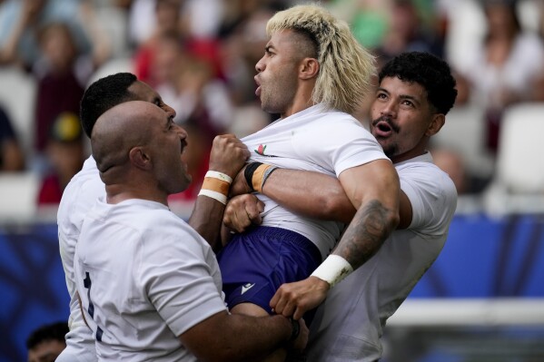 Samoa's Jonathan Taumateine, center, celebrates with teammates after scoring a try during the Rugby World Cup Pool D match between Samoa and Chile at the Stade de Bordeaux in Bordeaux, France, Saturday, Sept. 16, 2023. (AP Photo/Christophe Ena)