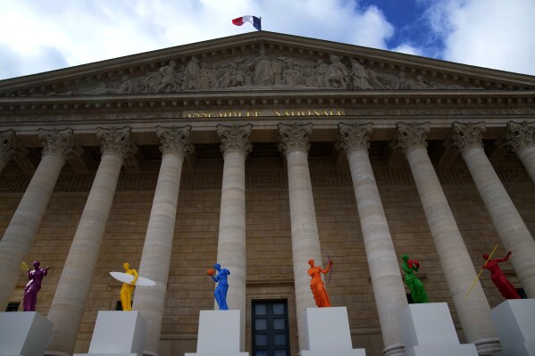 Copies of one of the most famous Greek statues, the Venus of Milo, are installed on the steps of the French National Assembly in Paris, France, Monday, April 15, 2024, to celebrate the Olympic spirit. The Venus, by artist Laurent Perbos, has regained her arms and is now equipped with the attributes of six sporting disciplines. (AP Photo/Christophe Ena)