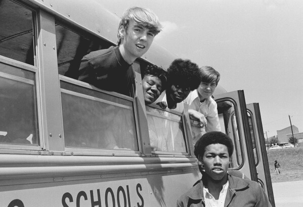 FILE - Students from Charlotte High School in Charlotte, N.C., ride a bus together, May 15, 1972. Friday, May 17, 2024, marks 70 years since the U.S. Supreme Court ruled that separating children in schools by race was unconstitutional. On paper, Brown v. Board of Education still stands. In reality, school integration is all but gone, the victim of a gradual series of court cases that slowly eroded it, leaving little behind. (AP Photo/Harold L. Valentine, File)