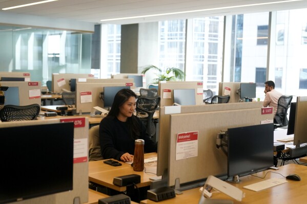 File - People work at the Yelp office in San Francisco on Feb. 14, 2023. The COVID-19 pandemic upended the work habits of people around the world, with millions working from home, at least for part of their week. Workers have returned in waves back to the office on some days, but navigating that transition is a significant hurdle for employers and workers alike. (AP Photo/Jeff Chiu, File)