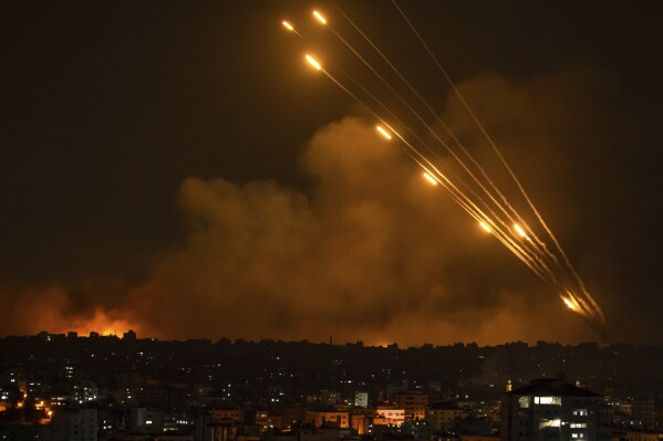 Rockets are fired toward Israel from the Gaza Strip on Sunday, Oct. 8, 2023. (AP Photo/Fatima Shbair)