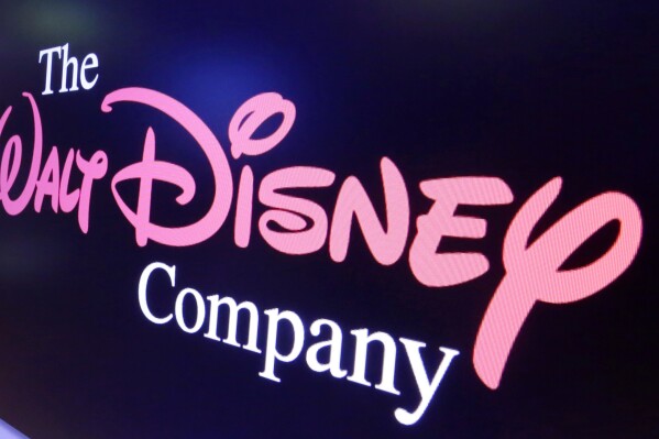 FILE - The Walt Disney Co. logo appears on a screen above the floor of the New York Stock Exchange on Aug. 7, 2017. Disney reported narrower losses on its Disney+ streaming platform in the quarter ended July 1, 2023, and boosted revenues, but also shed Disney+ subscribers for the second quarter in a row. (AP Photo/Richard Drew, File)