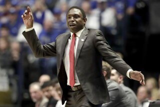 Alabama head coach Avery Johnson watches the action in the first half of an NCAA college basketball game against Kentucky at the Southeastern Conference tournament Friday, March 15, 2019, in Nashville, Tenn. (AP Photo/Mark Humphrey)