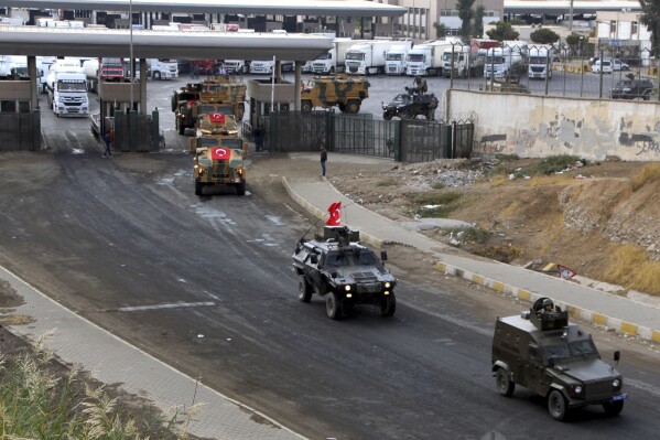 FILE - Turkish Army vehicles are driven away on a convoy at the Habur/Ibrahim Khalil border crossing with Iraq, near Silopi, southeastern Turkey, Tuesday, Oct. 31, 2017. At least 6 Turkish soldiers killed in attacks by Kurdish fighters in northern Iraq, Ankara says on Thursday, Aug, 10, 2023. (DHA-Depo Photos via AP, File)