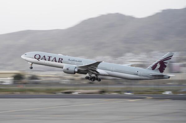 FILE - A Qatar Airways aircraft takes off with foreigners from the airport in Kabul, Afghanistan, on Sept. 9, 2021. World Cup host nation Qatar, said Monday, Nov. 14, 2022, that it will count emissions produced from daily flights ferrying fans during the tournament between the Gulf emirates toward the event’s overall carbon footprint. (AP Photo/Bernat Armangue, File)