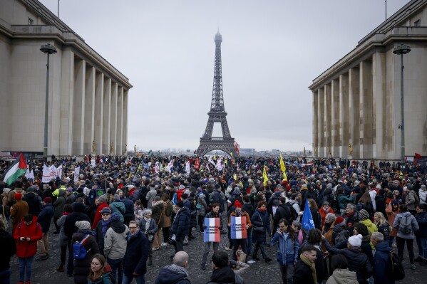 Opponents of France's immigration law protest at Trocadero Plaza near Eiffel Tower during a protest in Paris, Sunday, Jan. 21, 2024. The Constitutional Council is reviewing next week the government's controversial immigration law, to check that measures is in line with the Constitution. (AP Photo/Thomas Padilla)