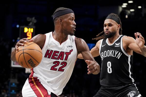Miami Heat forward Jimmy Butler (22) drives to the net against Brooklyn Nets guard Patty Mills (8) during the first half of an NBA basketball game, Wednesday, Oct. 27, 2021, in New York. (AP Photo/John Minchillo)