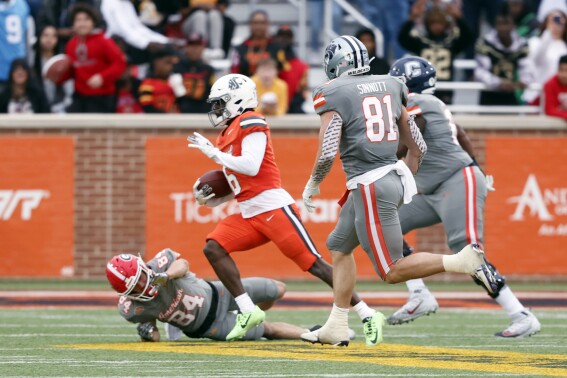 National defensive back Chau Smith-Wade of Washington State (6) eludes the tackle of American wide receiver Ladd McConkey of Georgia (84) as he returns an interception 83 yards the one-yard line during the second half of the Senior Bowl NCAA college football game, Saturday, Feb. 3, 2024, in Mobile, Ala. (AP Photo/ Butch Dill)
