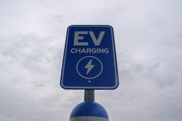 A sign is displayed at an electric vehicle charging station, March 8, 2024, in London, Ohio. (AP Photo/Joshua A. Bickel, File)