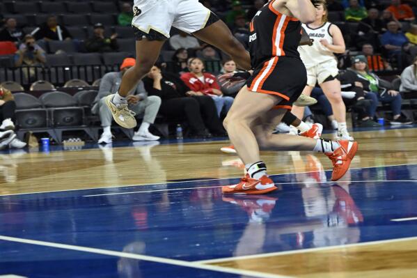 Colorado guard Jaylyn Sherrod (00) shoots against Oregon State's AJ Marotte during the second half of an NCAA college basketball game in the quarterfinals of the Pac-12 women's tournament Thursday, March 2, 2023, in Las Vegas. (AP Photo/David Becker)
