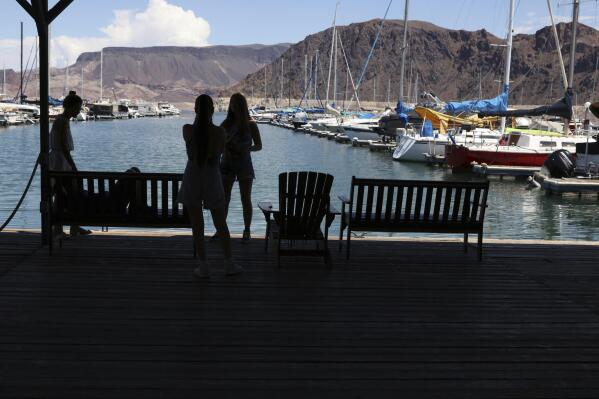 Visitors to Las Vegas Boat Harbor stand on the dock on Wednesday, Aug. 17, 2022. Unlike other states of the Colorado River Basin, Nevada has one main river user: Las Vegas. (Jeff Scheid/The Nevada Independent via AP)