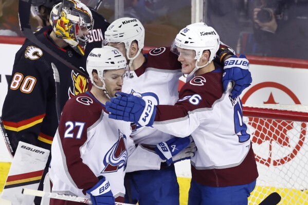 Colorado Avalanche's Mikko Rantanen, right. celebrates his goal against the Calgary Flames with Jonathan Drouin during the first period of an NHL hockey game Tuesday, March 12, 2024, in Calgary, Alberta. (Larry MacDougal/The Canadian Press via AP)