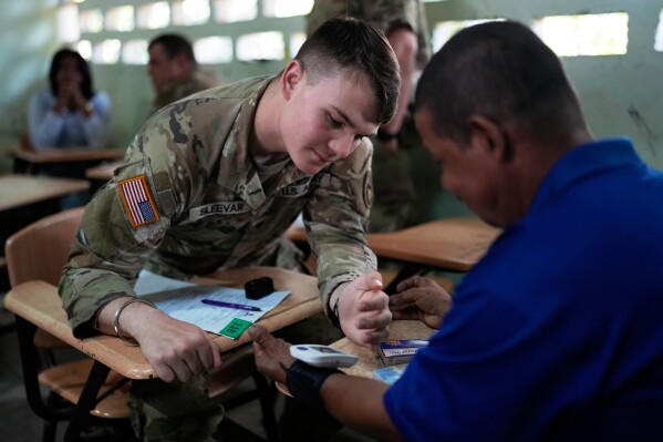 U.S. military members attend to patients as part of a program with Panama's Health Ministry, in Sardinilla, Panama, Thursday, March 27, 2025. (AP Photo/Matias Delacroix)