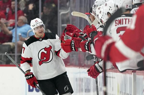 New Jersey Devils center Yegor Sharangovich greets teammates after his goal during the second period of an NHL hockey game against the Detroit Red Wings, Tuesday, Oct. 25, 2022, in Detroit. (AP Photo/Carlos Osorio)
