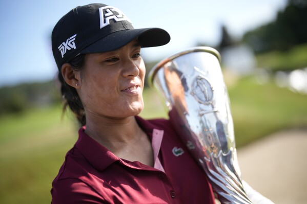 France's Celine Boutier poses with her trophy after winning the Evian Championship women's golf tournament in Evian, eastern France, Sunday, July 30, 2023. (AP Photo/Lewis Joly)