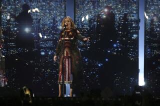FILE - Singer Adele performs onstage at the Brit Awards 2016 at the 02 Arena in London, Wednesday, Feb. 24, 2016.  Adele has postponed a 24-date Las Vegas residency hours before it was to start, citing delivery delays and coronavirus illness in her crew. The chart-topping British singer said she was “gutted” and promised to reschedule the shows. In a video message posted on social media, a tearful Adele said: “I’m so sorry but my show ain’t ready.” (Photo by Joel Ryan/Invision/AP, File)