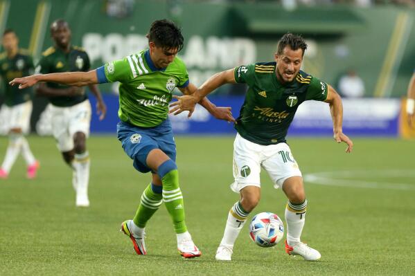 Timbers midfielder Sebastian Blanco, right, navigates around a Sounders defender as the Portland Timbers face the Seattle Sounders in an MLS match at Providence Park on Sunday, Aug. 15, 2021. (Sean Meagher/The Oregonian via AP)