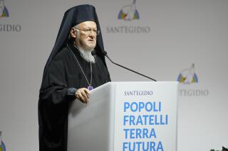 FILE - In this Oct. 6, 2021 file photo, Ecumenical Patriarch of Constantinople Bartholomew I delivers his speech at the interreligious meeting 'Brother peoples, future land" organized by the Sant'Egidio Community at 'La Nuvola' (the cloud) convention center in Rome.   The spiritual leader of the world’s 200 million Eastern Orthodox Christians brings an agenda spanning political, environmental and religious concerns to a 12-day U.S. visit beginning Saturday, Oct. 23.  (AP Photo/Gregorio Borgia, File)