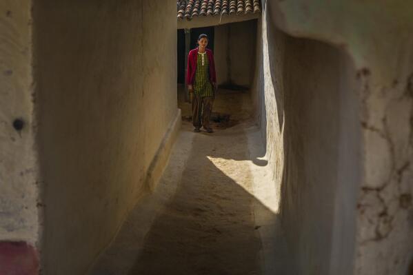 Sickle cell patient Poonam Gond, 19, walks out of her house in Haripur village in Ambikapur district, Chhattisgarh state, India, Monday, March 20, 2023. Gond has crippling pain as a result of poor access to treatment for her disease. Health inequities aren't unique to India, but the sheer scale of its population means that fragile systems are severely stretched. For the poor, this can have devastating consequences. (AP Photo/Rafiq Maqbool)