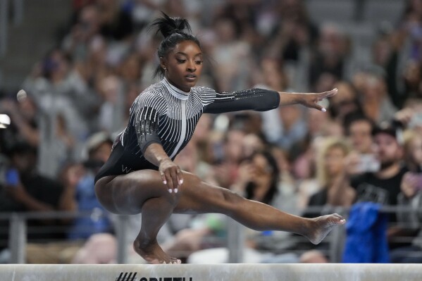 FILE - Simone Biles competes on the beam during the U.S. Gymnastics Championships, Friday, May 31, 2024, in Fort Worth, Texas. The seven-time Olympic medalist is aiming for redemption after removing herself from multiple finals at the Tokyo Games to focus on her mental health. (AP Photo/Jim Cowsert, FIle)