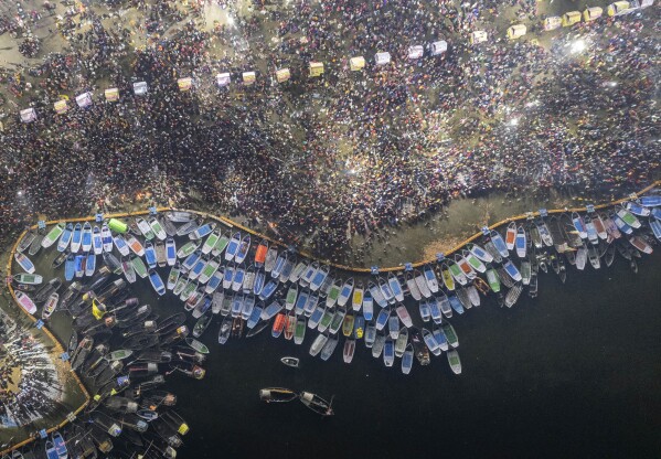 Hindu devotees crowd the Sangam, the confluence of the rivers, the Ganges, Yamuna and the mythical Saraswati, to take a holy dip on Mauni Amavasya, or the new moon day which is the most auspicious day during the annual month long Hindu religious fair "Magh Mela" in Prayagraj, India, Saturday, Jan. 21, 2023. (AP Photo/Satya Prakash)